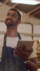 Man, carpenter and thinking with tablet at workshop for manufacturing, review and smile for furniture design. Person, artisan and tech with notes, checklist or app for project at woodwork factory