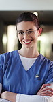 Happy, crossed arms and face of nurse in hospital with confidence for about us with nursing career. Smile, professional and portrait of female healthcare worker with pride for medical support job.