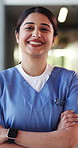 Crossed arms, woman and face of nurse in hospital with confidence for about us with nursing career. Happy, professional and portrait of female healthcare worker with pride for medical support job.