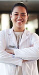 Face, doctor and woman with arms crossed, hospital or confident for health service and career growth. Happy, medical professional and Asian person with duty to help, wellness and pride in clinic
