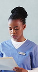 Black woman, doctor and reading with folder at hospital for medical file, patient history and test results. Person, document and notes for healthcare, referral letter and consent report for treatment