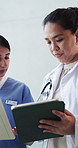 Doctors, team and tablet with discussion in corridor with medical report, documents and advice at hospital. Women, talk and healthcare professional with insight, tech or app for feedback at clinic