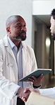 Doctor, documents and people in hospital, handshake and feedback for medical service. Welcome, physician or nurse in clinic, conversation or paperwork for healthcare info, thank you or shaking hands