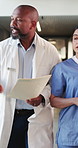 Doctor, nurse and stress with file in hospital for medical emergency, update or advice. Health team, people and anxiety in clinic hallway with treatment plan feedback, surgery schedule or urgency