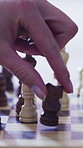 Hands, chess and knight with board game, piece and problem solving with strategy, play and competition in home. Person, wooden toys and move horse with contest, challenge and match at apartment