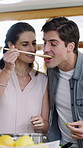 Cooking, taste and couple in kitchen with spoon for meal prep, healthy lunch and dinner recipe together. Happy, dating and woman with man by stove with food for nutrition, vitamins and wellness