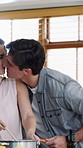 Cooking, kiss and couple in kitchen with food for meal prep, healthy lunch and dinner recipe together. Happy, dating and people with ingredients and vegetables for nutrition, vitamins and wellness