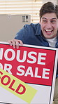 Happy man, house and sold with sign for picture, memory or capture moment together in new home. Excited, male person or homeowner with smile, photography or post for property investment together