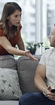 Cellphone, upset and couple with argument on sofa in living room for divorce, affair or breakup. Phone, angry and man with woman, fighting and text for online infidelity on dating app in home