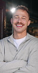 Face, man and smile with arms crossed at cafe for welcome, friendly server and customer service. Portrait, person and confident at front door, proud employee and hospitality industry at restaurant