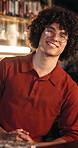 Happy, man and face of barista in cafe with confidence at for welcome and customer service. Smile, glasses and portrait of male waiter with pride for hospitality career at restaurant or coffee shop.
