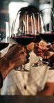 People, hands and cheers with wine glass for celebration, social gathering or bonding in restaurant. Happy, group or friends with alcohol toast for event, get together or party in local pub or bar