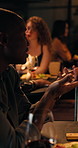 Night, couple and happy with talking in restaurant for first date, connection and romantic questions. Dinner, food or people with conversation at table for introduction chat, listening or interaction