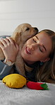 Happy, woman and bonding with puppy, bedroom and hug with domestic animal on bed, love and together. Home, person and dog mom with golden retriever, embrace and affection for pet or relax on break