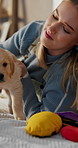 Relax, playing and woman on bed with puppy for bonding, relationship and development. Home, pet owner and person with Labrador dog in bedroom for comfort, cuddle and care for adoption on weekend