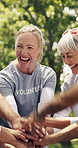 Group, woman and volunteer with handstack outdoor for charity, community service and teamwork. Smile, old people and hands together for social responsibility, solidarity and welfare outreach in park
