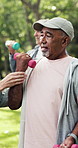 Fitness, class or old man in park with dumbbell, arm exercise or guidance in workout hobby together. Bokeh, senior people or coach with club, activity advice or group training in retirement.