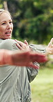 Personal trainer, woman and stretching for fitness, park and talk with clients, coaching or workout. Outdoor, instructor and person with smile for exercise routine, wellness and training in nature