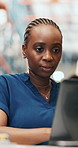 Woman, laptop and typing at warehouse for logistics with shipping, inventory management or report. Female person, tech and communication for storage, schedule and supply chain with quality control