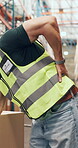 Logistics, hand and employee with back pain, warehouse and accident at work, injury and inflammation. Factory, worker and person with muscle strain, hurt and massage for joint tension or burnout