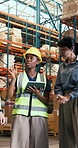 Logistics, group and woman with tablet, warehouse and discussion with colleagues for stock delivery. People, talk and project manager with tech for goods distribution and supply chain in factory