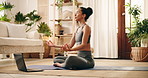 Laptop, meditation and yoga with woman in living room of home for inner peace or zen exercise. Breathing, fitness and virtual class with calm yogi person on floor of apartment for mindfulness