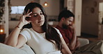 Conflict, sad and couple in house with tension, fight or disappointment in relationship affair. Upset, man or woman on couch with disagreement, frustration or crisis with marriage infidelity.