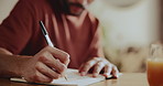 Hands, man and writing with notebook in home for planning, to do list and story structure. Male person, remote work and journal with orange juice, interview questions and ideas of article publication