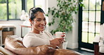 Coffee, relax and face of woman on sofa in home for smile, wellness drink and self care. Happiness, weekend break and comfortable with female person and herbal tea in living room of apartment
