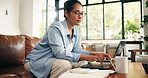 Woman, laptop and calculator for budget in home with review, typing and glasses for bills in lounge. Person, computer and documents with taxes, fintech or report for asset management at apartment