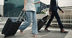 Business people, legs and walking with suitcase in city for travel, work trip or commute together. Employees, colleagues or travelers with luggage for career pursuit or job opportunity in urban town