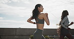 Friends, women and running in city for health, cardio fitness and smile on bridge outdoor. Wellness, people and jog together for workout, endurance training or runners exercise in town for sports