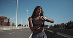 Smart watch, fitness and black woman on highway for distance, wellness or running check in city. Health, sports tech and African female athlete on bridge for cardio workout, exercise or training.