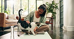 Yoga, woman and stroke cat in home for fitness break, connection and furry companion. Kitty owner, happy yogi and playing with pet on mat for post exercise, bonding together and loyalty in apartment