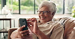 Funny, phone and elderly woman in home for relax, comedy post or scroll in retirement on sofa. Laugh, smile or senior person with mobile for joke, online communication or reading meme on social media