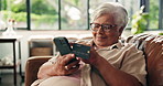 Old woman, smartphone and credit card for online shopping in home, purchase or checkout with account info. Senior female person, ecommerce or internet banking with transaction for payment at house