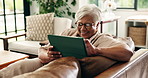 Senior woman, tablet and reading at house with laughing for communication, network and comedy blog. Old person, funny chat or relax with ebook, digital tech and internet for forum in retirement home