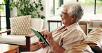 Senior woman, tablet and scroll online in home with smile for communication, network and laugh with thinking. Old person, funny chat or happy reflection with digital tech and internet in retirement