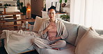 Breathing, relax and woman on sofa in home for meditation, mindfulness and balance in morning. Zen, calm and female person in living room with yoga practice for health or wellness in apartment.