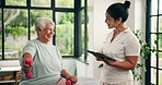 Physical therapy, dumbbells or old women with tablet in clinic, medical recovery evaluation or arm exercise. Speaking, tech or people with injury assessment for healing progress, thumbs up or smile