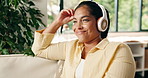 Thinking, woman or laugh with headphones on sofa for comedy podcast, happy memory and relax. Streaming, peaceful person and thoughtful in home for funny radio show, audiobook humor and weekend break