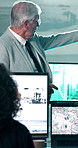 Man, presentation and surveillance in control room with computer screen, safety training or discussion. Manager, people and talk in security agency with CCTV tech, risk assessment advice or workshop.