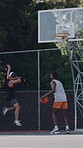 Celebration, basketball and men at court for sports, competition and teamwork for exercise outdoor. Players, score and people throw ball for fitness, training and game winner with jump for goal