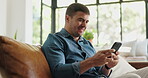 Typing, smile and man on couch with phone, post reaction and communication on email platform. Happy, reading and male person in house with tech, social media update and message on digital app.