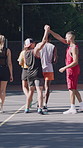 Sports, people and high five on basketball court for game, success and community support for workout. Team building, winner and fitness celebration with players for competitive exercise for match