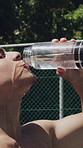 Thirsty, man and drinking water for fitness outdoor with bottle, hydration and exercise recovery. Shirtless, male person and pouring liquid on face, sweat control and cool down from sports challenge