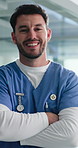 Crossed arms, nurse and face of man in hospital for medical service, confidence and healthcare career. Professional, clinic and portrait of person in lobby for health support, pride and about us