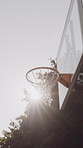 Sports, sunshine and net outdoor for basketball, hoop fabric and equipment for practice session. Summer, flare and ring setup on court for workout activity, rim and game training in fitness hobby.
