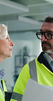 Architect, team and discussion with blueprint in building for renovation design, inspection or ideas. Architecture, mature people or floor plan on site for commercial development or office remodeling