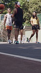Group, friends and talk at basketball court with smile, social gathering and low angle in summer. Men, women and happy outdoor at urban park with sport contest, games and walk for match in town